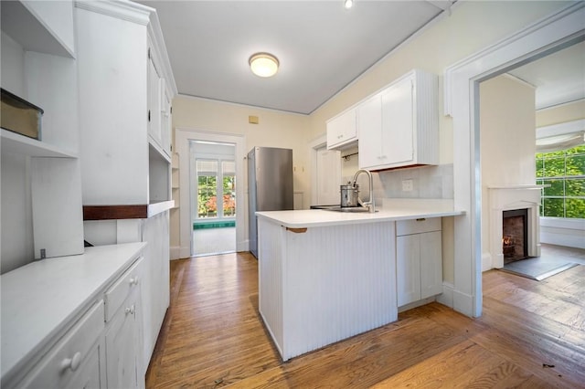33 Kay St, Newport, RI 02840 - kitchen featuring a peninsula, open shelves, wood finished floors, and light countertops