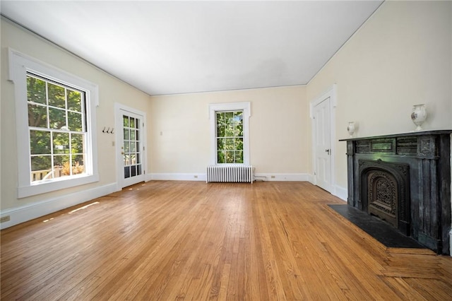 33 Kay St, Newport, RI 02840 - unfurnished living room featuring radiator heating unit, a fireplace with flush hearth, and light wood finished floors