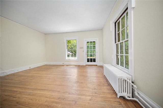 33 Kay St, Newport, RI 02840 - unfurnished room with radiator heating unit and light wood finished floors