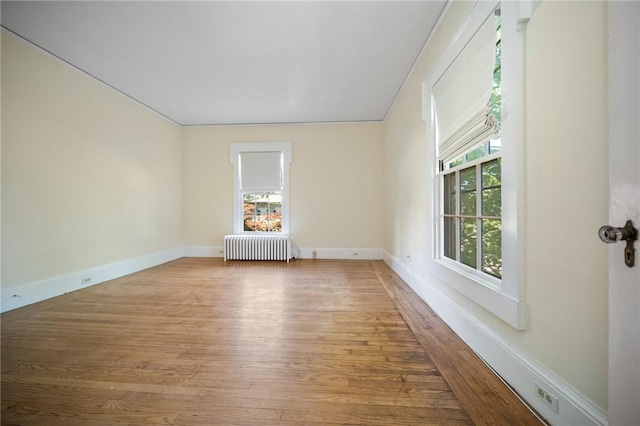 33 Kay St, Newport, RI 02840 - empty room with radiator heating unit and wood finished floors