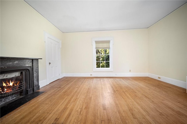 33 Kay St, Newport, RI 02840 - unfurnished living room featuring light wood-style flooring and a fireplace with flush hearth