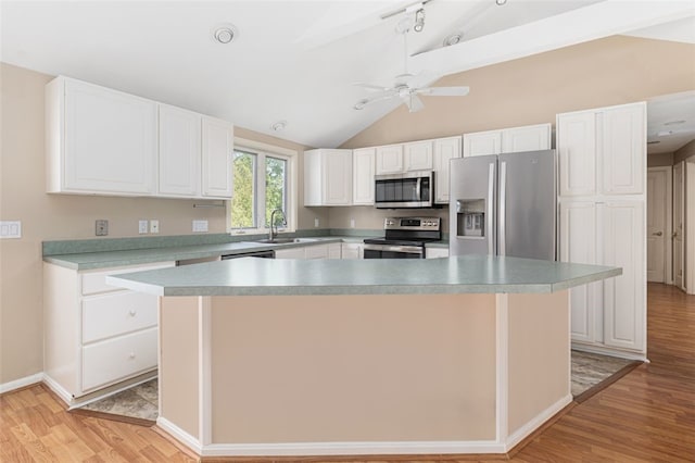 151 Mohawk Trl, Cranston, RI 02921 - kitchen featuring stainless steel appliances, light wood finished floors, lofted ceiling, white cabinetry, and a ceiling fan