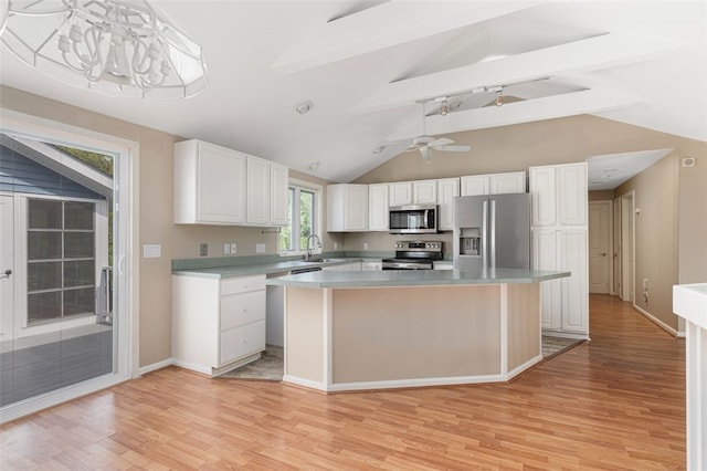 151 Mohawk Trl, Cranston, RI 02921 - kitchen featuring stainless steel appliances, light wood-style floors, white cabinetry, and a kitchen island