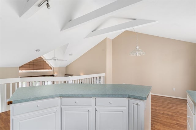 151 Mohawk Trl, Cranston, RI 02921 - kitchen featuring light wood-type flooring, white cabinets, beamed ceiling, decorative light fixtures, and a ceiling fan