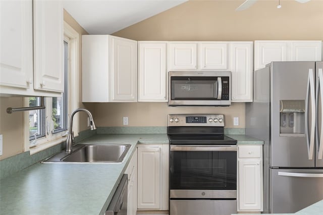151 Mohawk Trl, Cranston, RI 02921 - kitchen with stainless steel appliances, white cabinets, lofted ceiling, and light countertops
