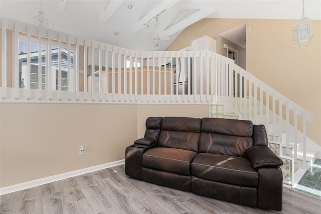 151 Mohawk Trl, Cranston, RI 02921 - living room with wood finished floors, lofted ceiling, and stairway