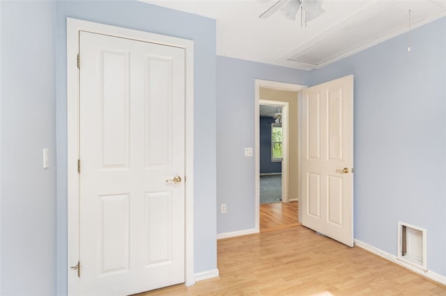 151 Mohawk Trl, Cranston, RI 02921 - unfurnished bedroom featuring attic access, light wood finished floors, and a ceiling fan