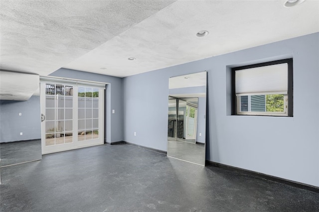 151 Mohawk Trl, Cranston, RI 02921 - empty room with a textured ceiling and concrete flooring
