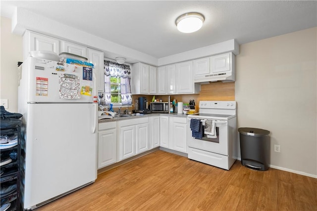 40 Agnes St, East Providence, RI 02914 - kitchen featuring white appliances, under cabinet range hood, light wood-style floors, and white cabinets