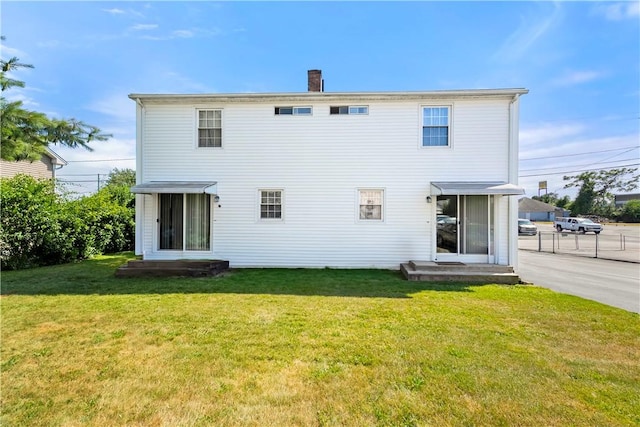40 Agnes St, East Providence, RI 02914 - rear view of house with a lawn and a chimney