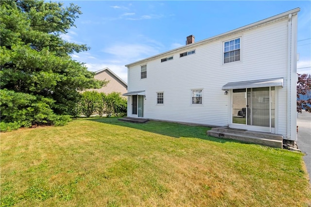 40 Agnes St, East Providence, RI 02914 - back of house featuring entry steps, a lawn, and a chimney