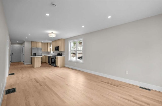 129 Stanwood St, Providence, RI 02907 - kitchen with appliances with stainless steel finishes, light countertops, open floor plan, light wood-type flooring, and recessed lighting