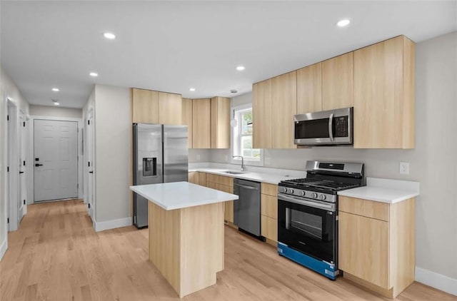 129 Stanwood St, Providence, RI 02907 - kitchen with stainless steel appliances, light brown cabinetry, light wood-type flooring, a center island, and recessed lighting