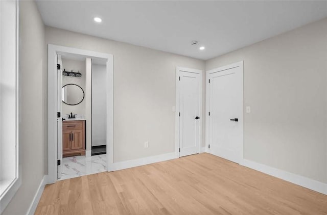 129 Stanwood St, Providence, RI 02907 - unfurnished bedroom with recessed lighting, light wood-type flooring, and ensuite bath