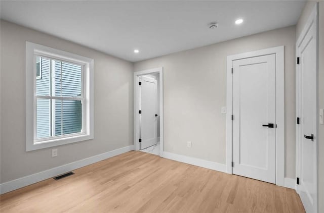 129 Stanwood St, Providence, RI 02907 - unfurnished bedroom with light wood-type flooring and recessed lighting