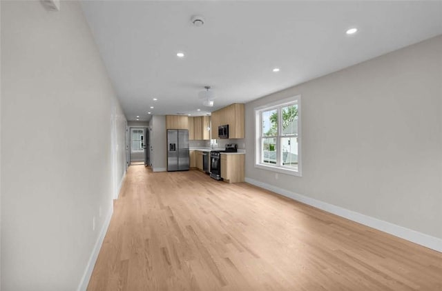 129 Stanwood St, Providence, RI 02907 - unfurnished living room featuring light wood-type flooring and recessed lighting