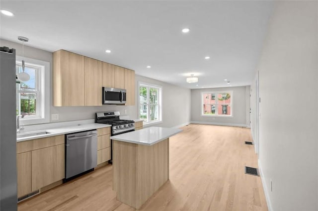 129 Stanwood St, Providence, RI 02907 - kitchen with stainless steel appliances, light brown cabinets, modern cabinets, light wood finished floors, and recessed lighting