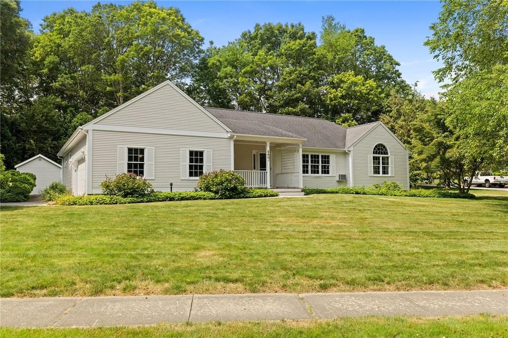 240 Mulberry Dr, South Kingstown, RI 02879 - view of front of home with covered porch, a front yard, and an attached garage