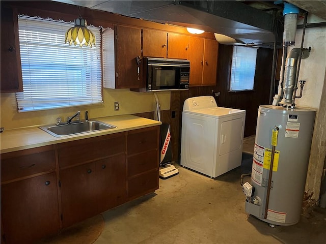 16 Winthrop St, Cranston, RI 02910 - kitchen with washer / clothes dryer, gas water heater, black microwave, unfinished concrete flooring, and light countertops