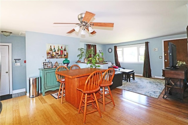 27 Louise Dr, Tiverton, RI 02878 - dining space with a ceiling fan, light wood-style flooring, and a bar