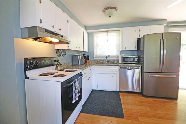 27 Louise Dr, Tiverton, RI 02878 - kitchen featuring appliances with stainless steel finishes, under cabinet range hood, white cabinetry, light wood-style flooring, and dark countertops