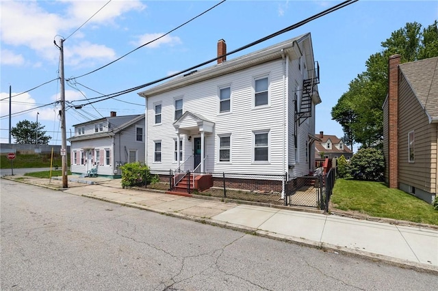 40 W Cole St, Pawtucket, RI 02861 - view of front of property featuring a chimney and a gate