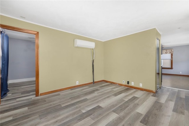 40 W Cole St, Pawtucket, RI 02861 - empty room with an AC wall unit, wood finished floors, and ornamental molding