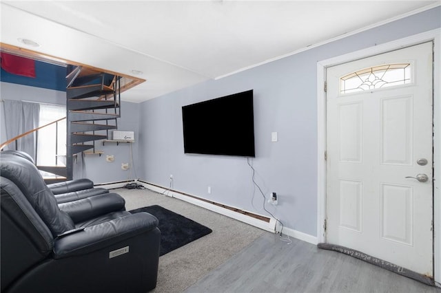 40 W Cole St, Pawtucket, RI 02861 - living area with a baseboard radiator, wood finished floors, stairs, and ornamental molding