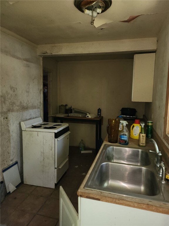 21 White Rock Rd, Westerly, RI 02891 - kitchen with white electric range, white cabinets, and tile patterned flooring