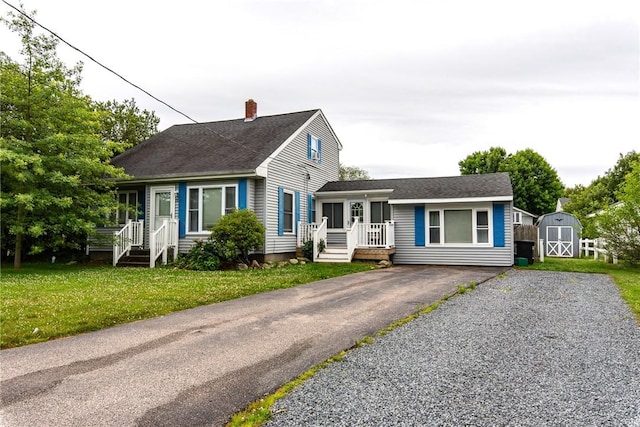 130 Knowlesway Ext, Narragansett, RI 02882 - view of front facade with a shed, a chimney, a shingled roof, and a front lawn