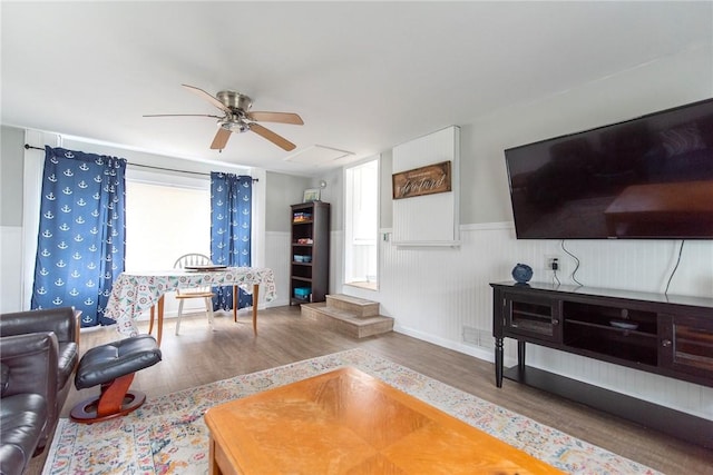 130 Knowlesway Ext, Narragansett, RI 02882 - living room featuring wood finished floors, healthy amount of natural light, a ceiling fan, and a wainscoted wall