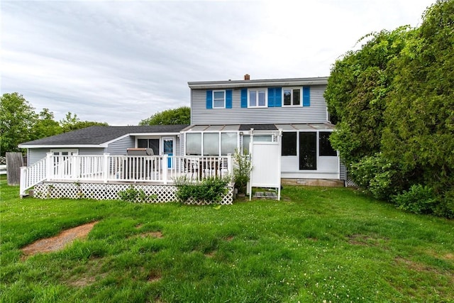 130 Knowlesway Ext, Narragansett, RI 02882 - rear view of property featuring a sunroom, a deck, and a yard