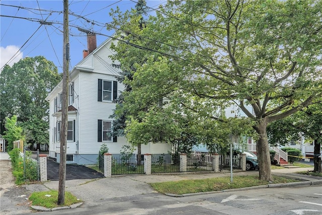 199 Linwood Ave, Providence, RI 02907 - view of front facade with a chimney and a fenced front yard