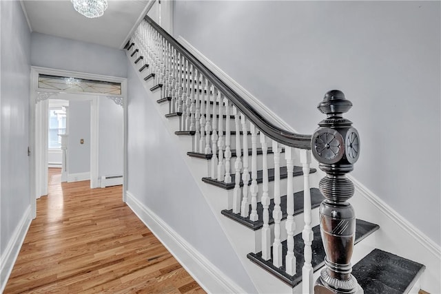 199 Linwood Ave, Providence, RI 02907 - stairs featuring a baseboard radiator, wood finished floors, and baseboard heating