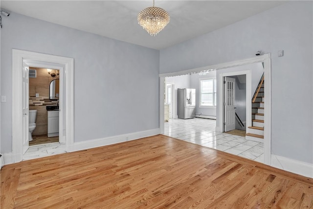 199 Linwood Ave, Providence, RI 02907 - spare room with a chandelier, stairs, light wood-type flooring, and a baseboard heating unit