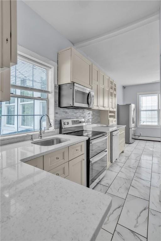 199 Linwood Ave, Providence, RI 02907 - kitchen featuring appliances with stainless steel finishes, decorative backsplash, light stone countertops, and light marble finish floors