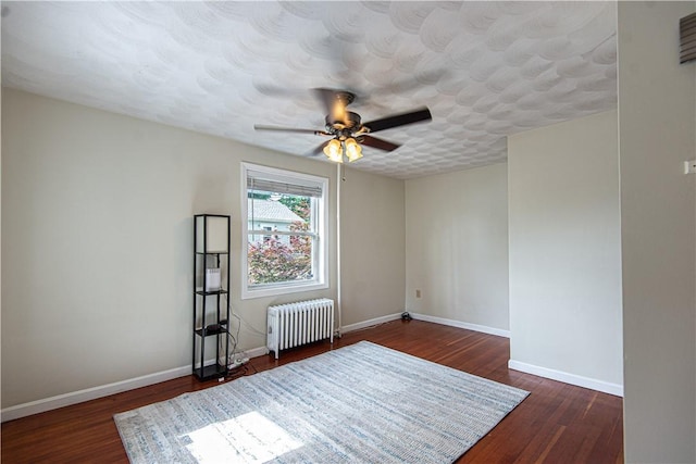 9 Locust St, Providence, RI 02906 - spare room featuring radiator, a ceiling fan, and wood finished floors