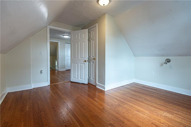 9 Locust St, Providence, RI 02906 - additional living space featuring lofted ceiling, wood finished floors, and a textured ceiling