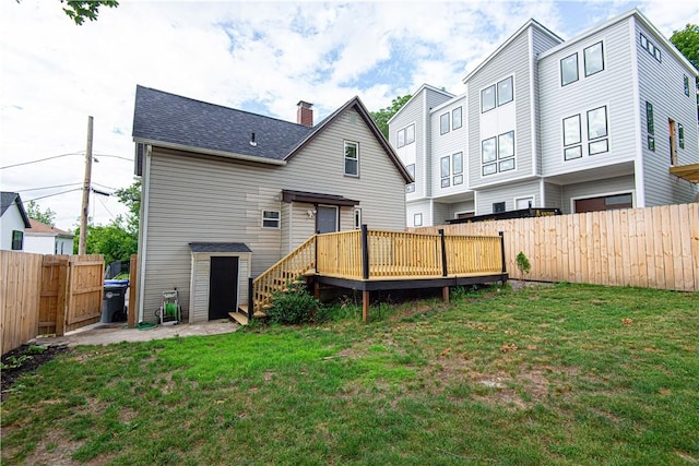 9 Locust St, Providence, RI 02906 - back of house with a wooden deck, a fenced backyard, a chimney, and a shingled roof