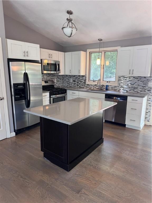 27 Brook St, West Warwick, RI 02893 - kitchen featuring stainless steel appliances, decorative backsplash, dark wood-type flooring, lofted ceiling, and pendant lighting
