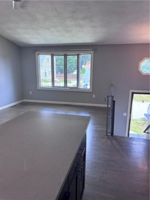 27 Brook St, West Warwick, RI 02893 - unfurnished living room with dark wood-type flooring and baseboards