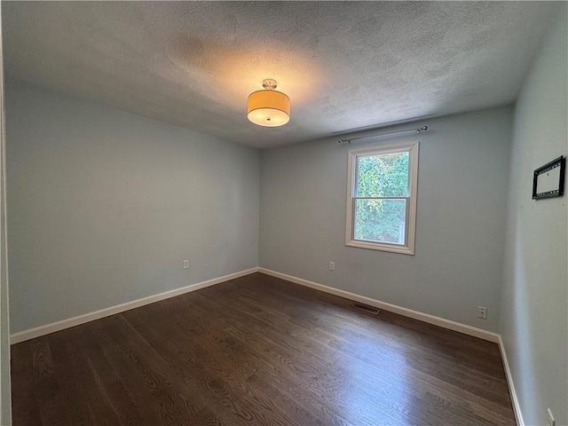 27 Brook St, West Warwick, RI 02893 - empty room featuring a textured ceiling and dark wood-style flooring
