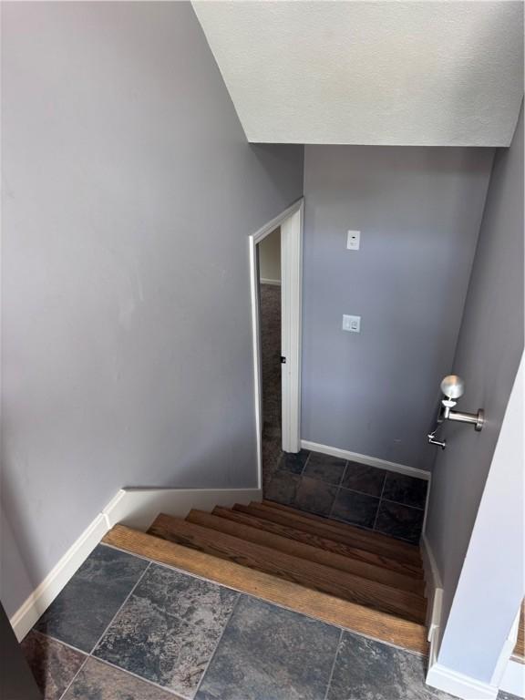 27 Brook St, West Warwick, RI 02893 - stairs featuring baseboards and tile patterned flooring