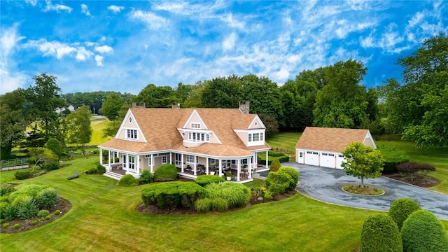 15 Courageous Cir, Bristol, RI 02809 - back of house featuring an outbuilding, a detached garage, and a yard