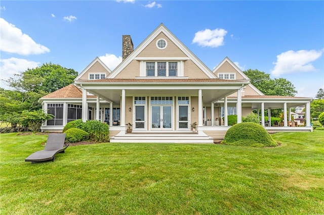 15 Courageous Cir, Bristol, RI 02809 - rear view of property featuring a chimney, a yard, and french doors