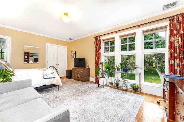 15 Courageous Cir, Bristol, RI 02809 - bedroom with crown molding, multiple windows, wood finished floors, and a desk