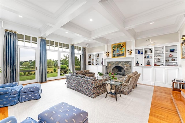 15 Courageous Cir, Bristol, RI 02809 - living area featuring beamed ceiling, ornamental molding, a stone fireplace, coffered ceiling, and wood finished floors