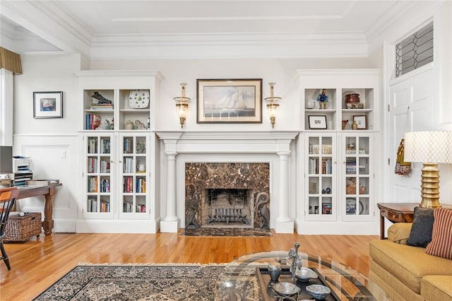 15 Courageous Cir, Bristol, RI 02809 - living area featuring wood finished floors, a tiled fireplace, and crown molding
