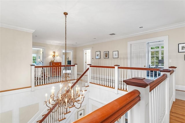 15 Courageous Cir, Bristol, RI 02809 - corridor featuring an upstairs landing, wood finished floors, healthy amount of natural light, crown molding, and a chandelier