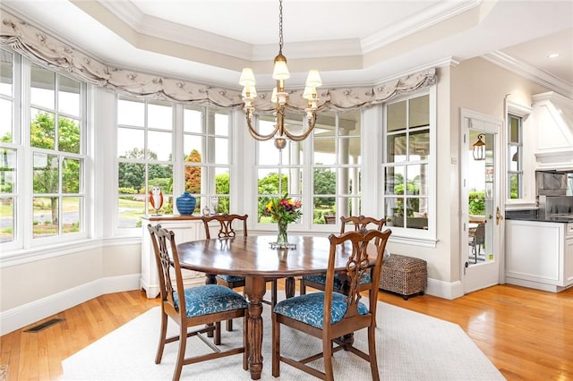 15 Courageous Cir, Bristol, RI 02809 - dining area with a chandelier, light wood finished floors, a raised ceiling, and crown molding